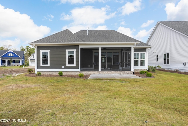 back of house with a sunroom and a lawn