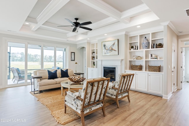 living room featuring coffered ceiling, light hardwood / wood-style flooring, ceiling fan, and crown molding