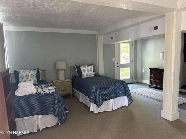 bedroom featuring a textured ceiling, carpet floors, and access to outside