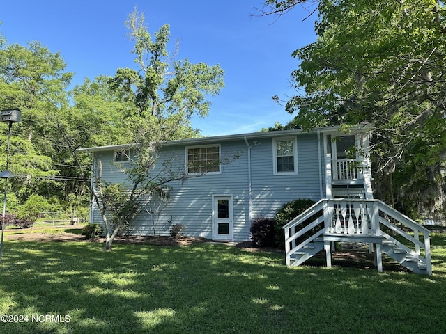 back of house with a yard