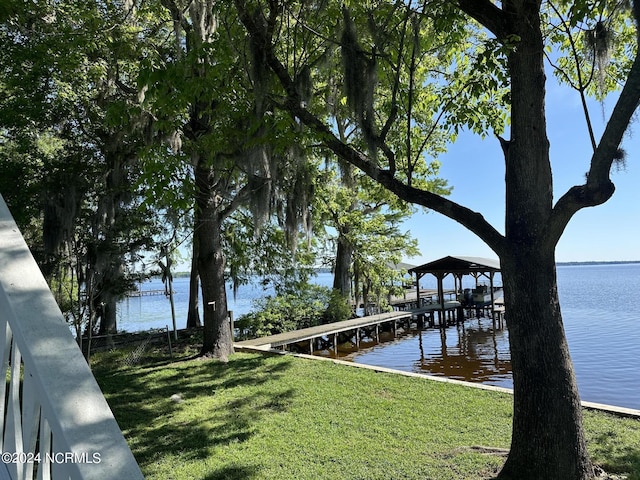 dock area featuring a water view and a yard