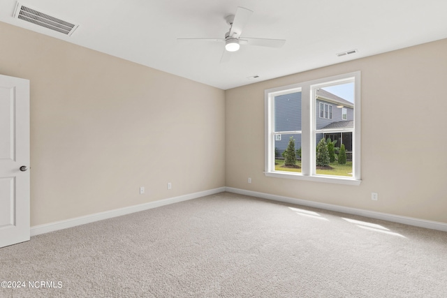 unfurnished room with visible vents, baseboards, carpet, and a ceiling fan