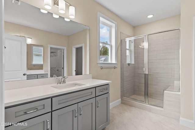 bathroom with vanity, a shower stall, and plenty of natural light