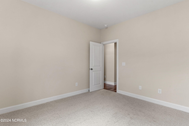 empty room with baseboards and carpet floors