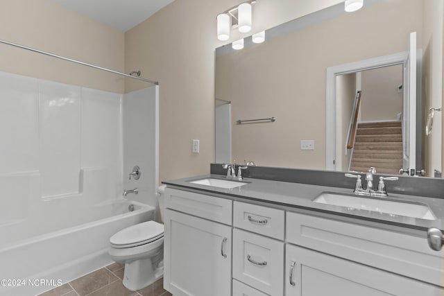 full bathroom featuring double vanity, toilet, shower / bathtub combination, and a sink