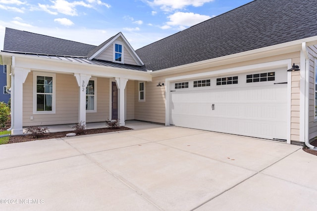 view of front of property with covered porch and a garage