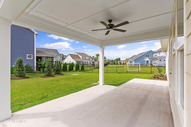 view of patio / terrace with a fenced backyard, a residential view, and a ceiling fan