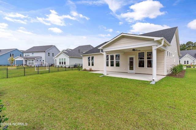 back of house with a fenced backyard, a lawn, ceiling fan, and a patio area