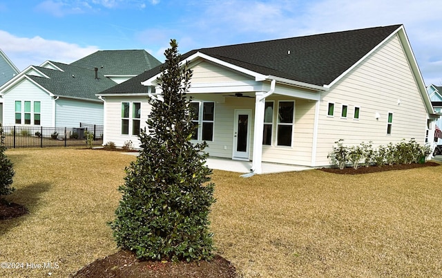 back of house featuring a patio area, a lawn, ceiling fan, and fence