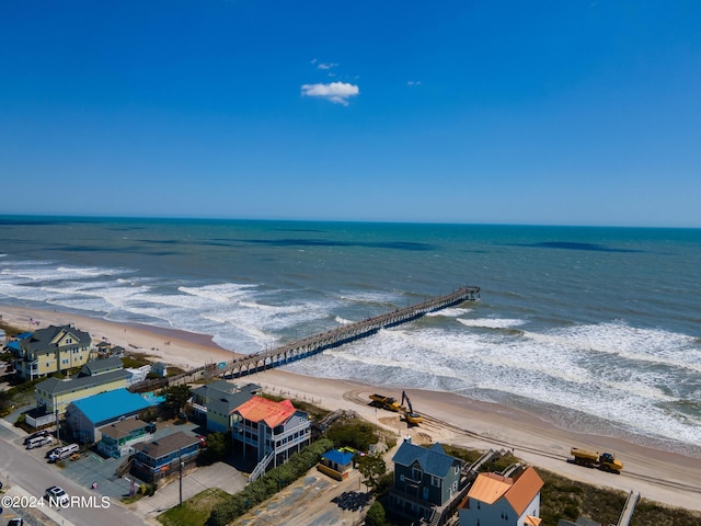 birds eye view of property featuring a beach view and a water view