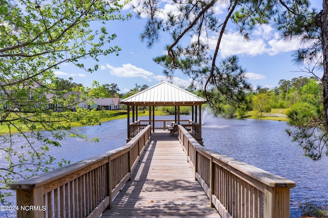 view of dock featuring a gazebo and a water view