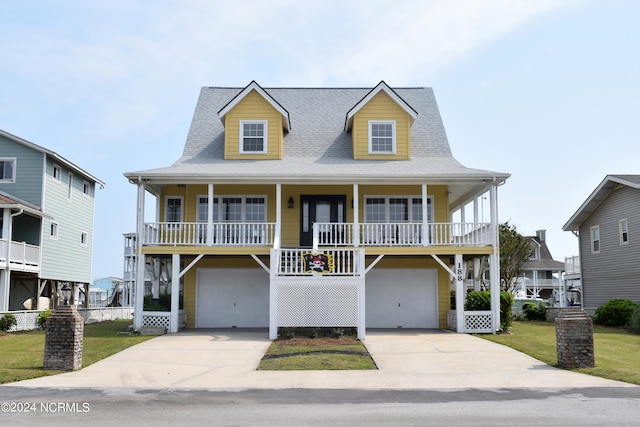 view of front facade featuring a garage, covered porch, and a front lawn