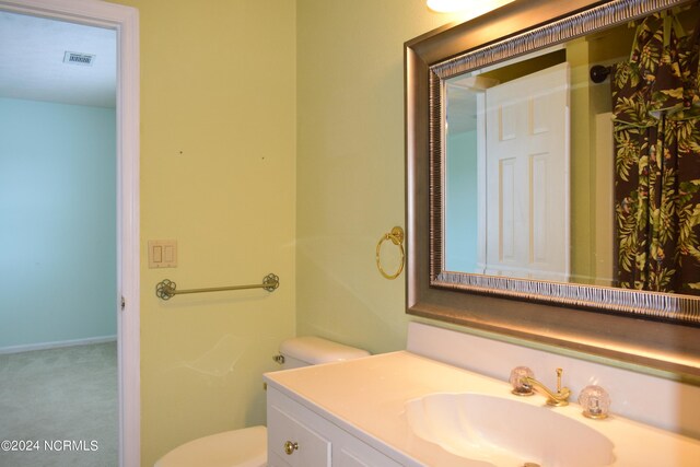 bathroom with vanity and toilet