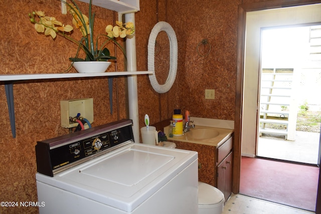 washroom with sink and washer / dryer