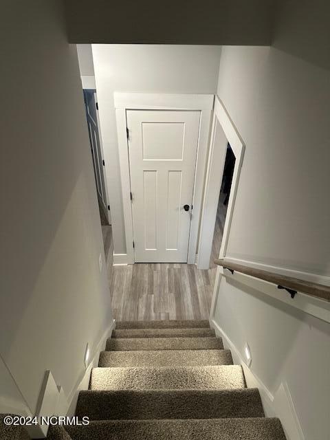 stairway featuring hardwood / wood-style floors