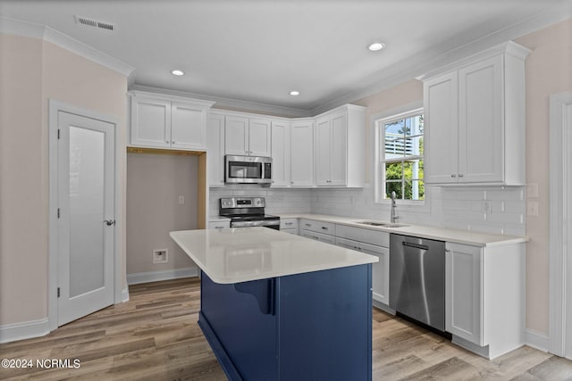 kitchen with stainless steel appliances, white cabinetry, and sink