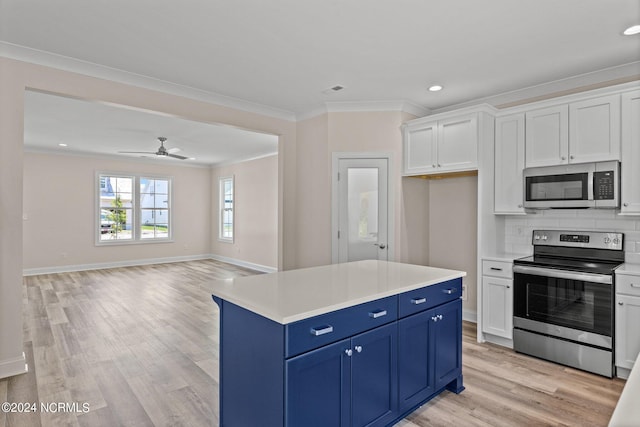 kitchen with white cabinets, stainless steel appliances, light hardwood / wood-style flooring, and blue cabinetry