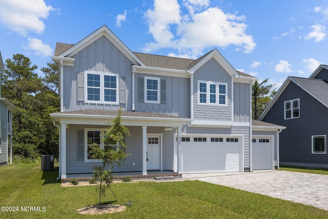 view of front of house with a porch, a garage, a front yard, and central AC