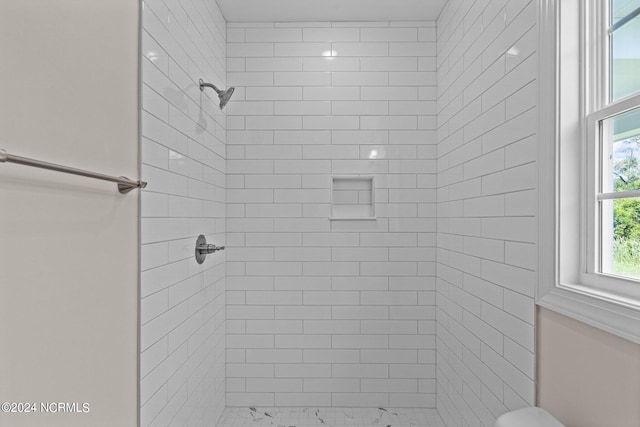 bathroom with a tile shower