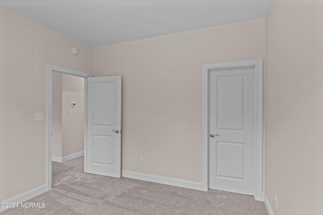 unfurnished bedroom with light colored carpet