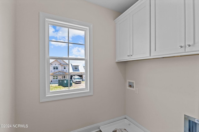 washroom featuring cabinets, washer hookup, and plenty of natural light