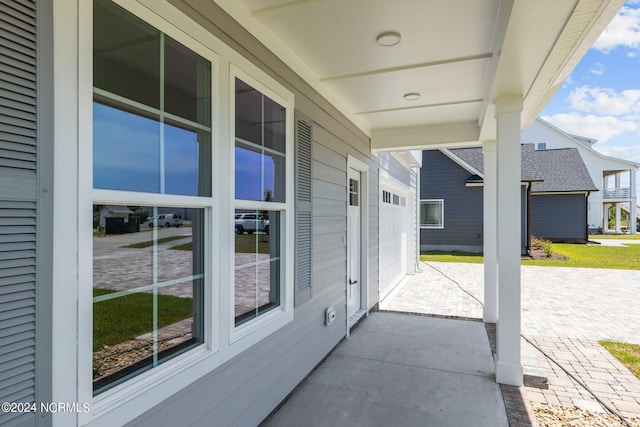 view of patio / terrace featuring a garage and covered porch