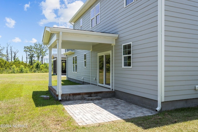 back of property featuring a yard and a patio area