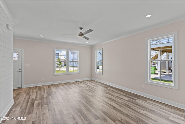 empty room with crown molding, light hardwood / wood-style flooring, and ceiling fan