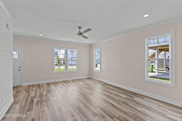 spare room featuring ornamental molding, ceiling fan, and light hardwood / wood-style floors