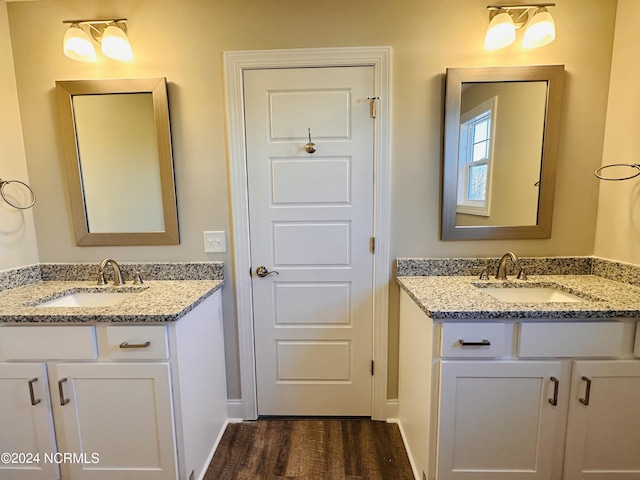 bathroom with wood-type flooring and double sink vanity