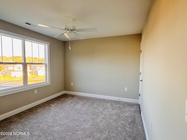 empty room with ceiling fan and carpet flooring