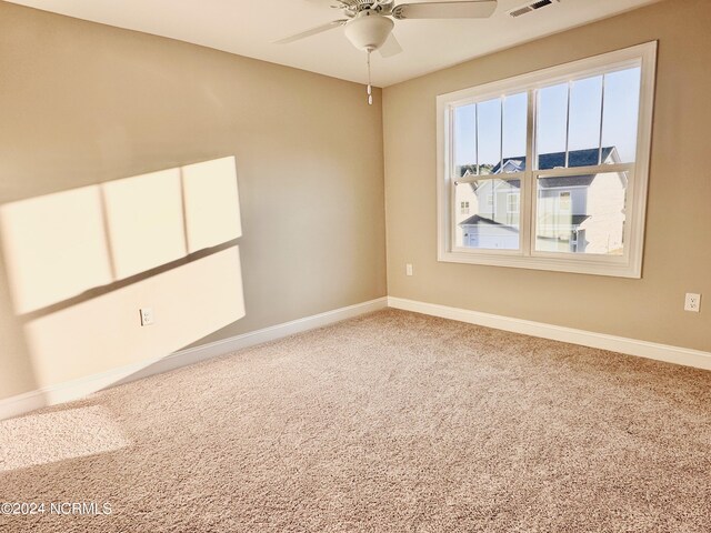 spare room featuring ceiling fan and carpet floors