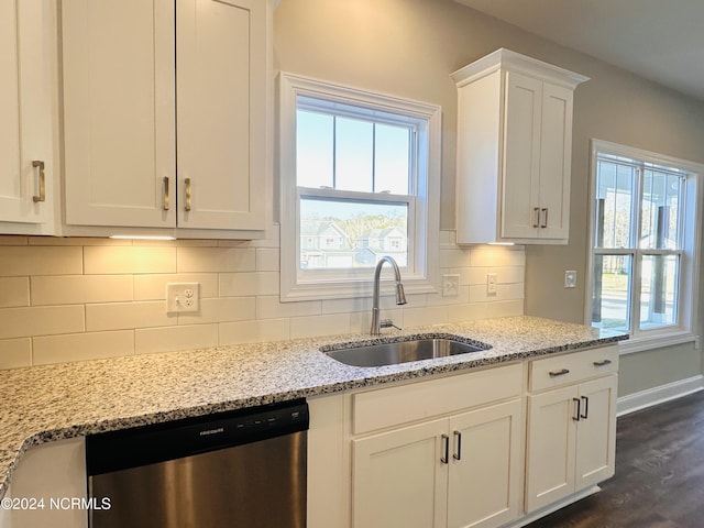 kitchen with sink, tasteful backsplash, white cabinetry, stainless steel dishwasher, and dark hardwood / wood-style floors