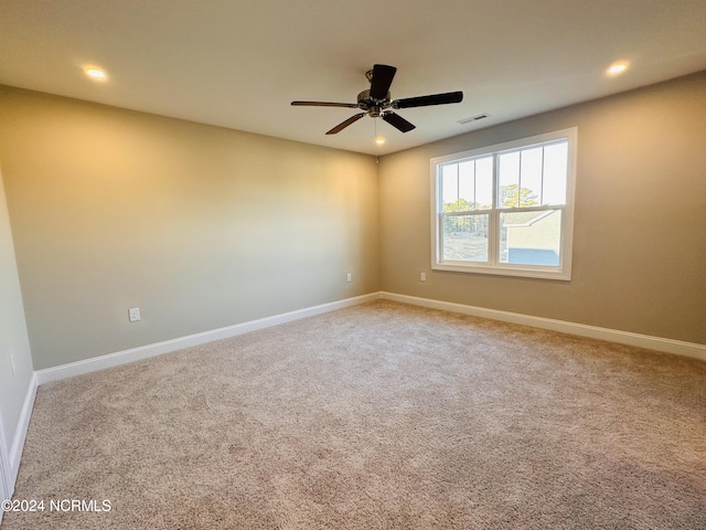 carpeted empty room featuring ceiling fan