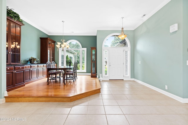 entrance foyer featuring a chandelier, light hardwood / wood-style floors, and crown molding