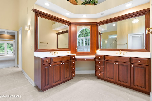 bathroom featuring tile floors, double sink, and vanity with extensive cabinet space