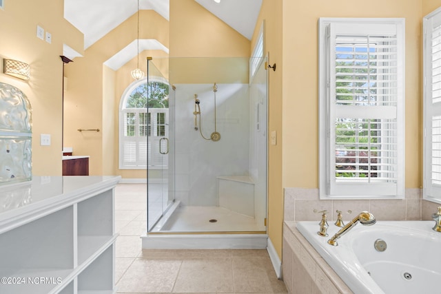 bathroom featuring vaulted ceiling, a wealth of natural light, and separate shower and tub