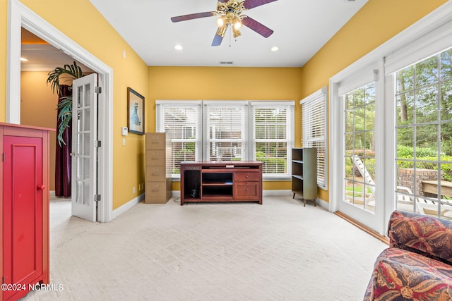 sunroom / solarium featuring ceiling fan