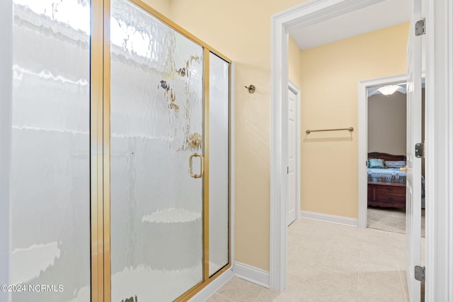 bathroom with walk in shower and tile flooring