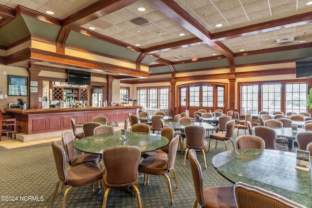 dining area featuring a wealth of natural light, beamed ceiling, coffered ceiling, and crown molding