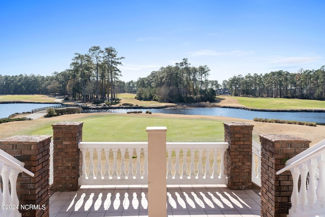 deck featuring a water view and a lawn