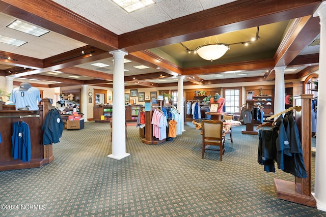 interior space featuring carpet, coffered ceiling, crown molding, and ornate columns