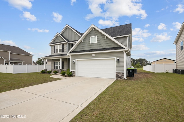 craftsman house featuring a garage, central AC, and a front lawn