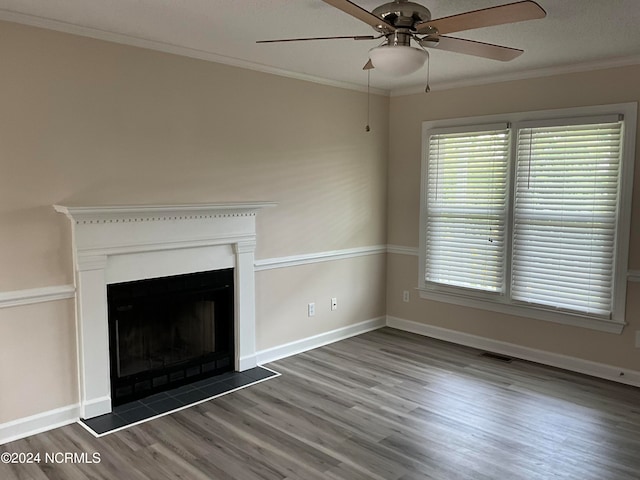 unfurnished living room with crown molding, dark hardwood / wood-style floors, and ceiling fan