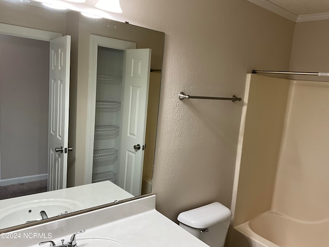 full bathroom with ornamental molding, washtub / shower combination, vanity, and toilet