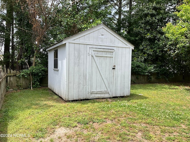 view of shed / structure with a lawn