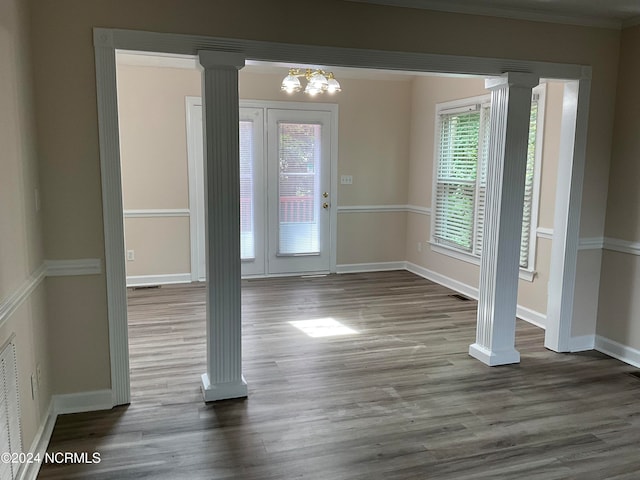 entrance foyer with decorative columns and dark hardwood / wood-style floors