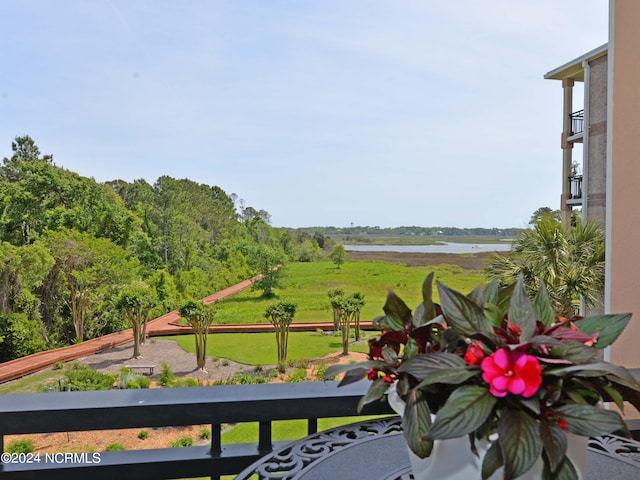 exterior space featuring a balcony and a water view