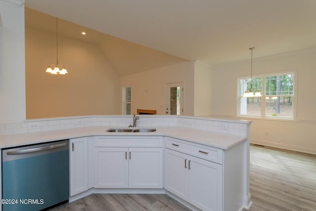 kitchen with a notable chandelier, light countertops, light wood-style flooring, a sink, and dishwashing machine