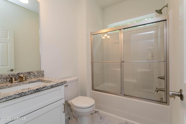 full bath with toilet, marble finish floor, enclosed tub / shower combo, and vanity